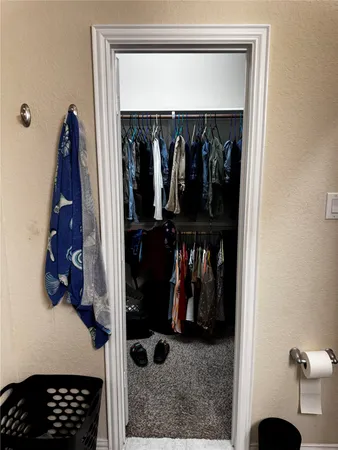 a bedroom with a bed and a mirror