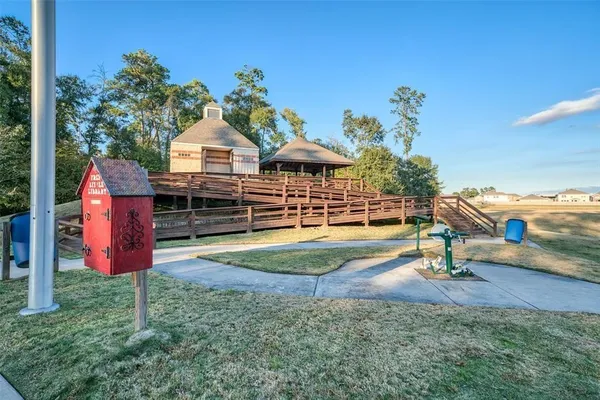 a view of a roof deck with wooden floor and roof with a small garden
