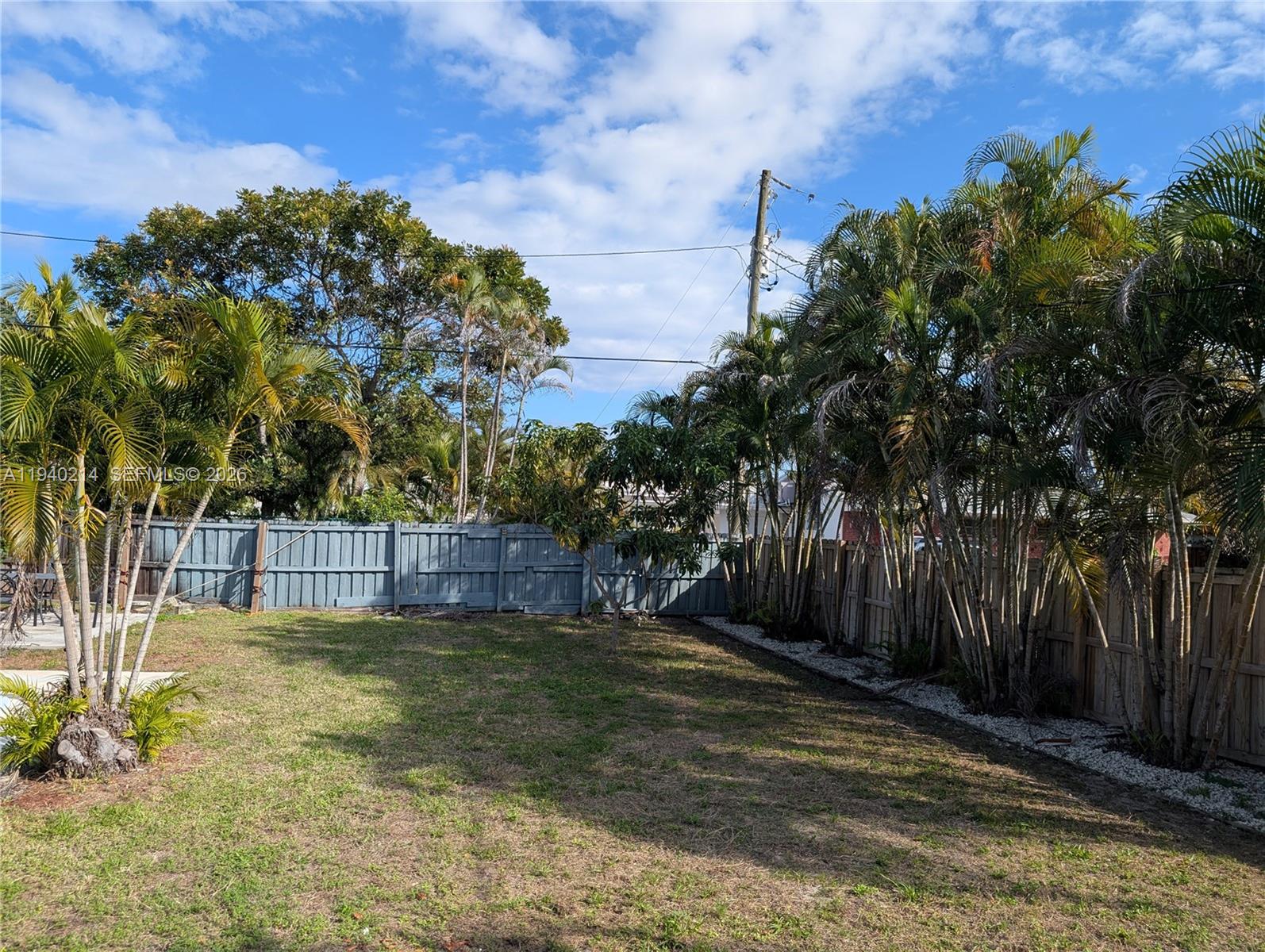 311 Southwest 2nd Avenue, Unit 1 Dania Beach, FL 33004 - Photo 12 of 14 a view of a backyard with large trees