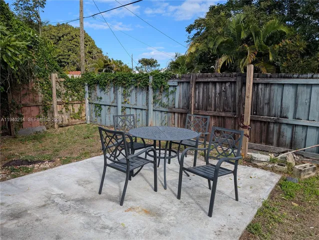 a view of a chairs and table in the patio