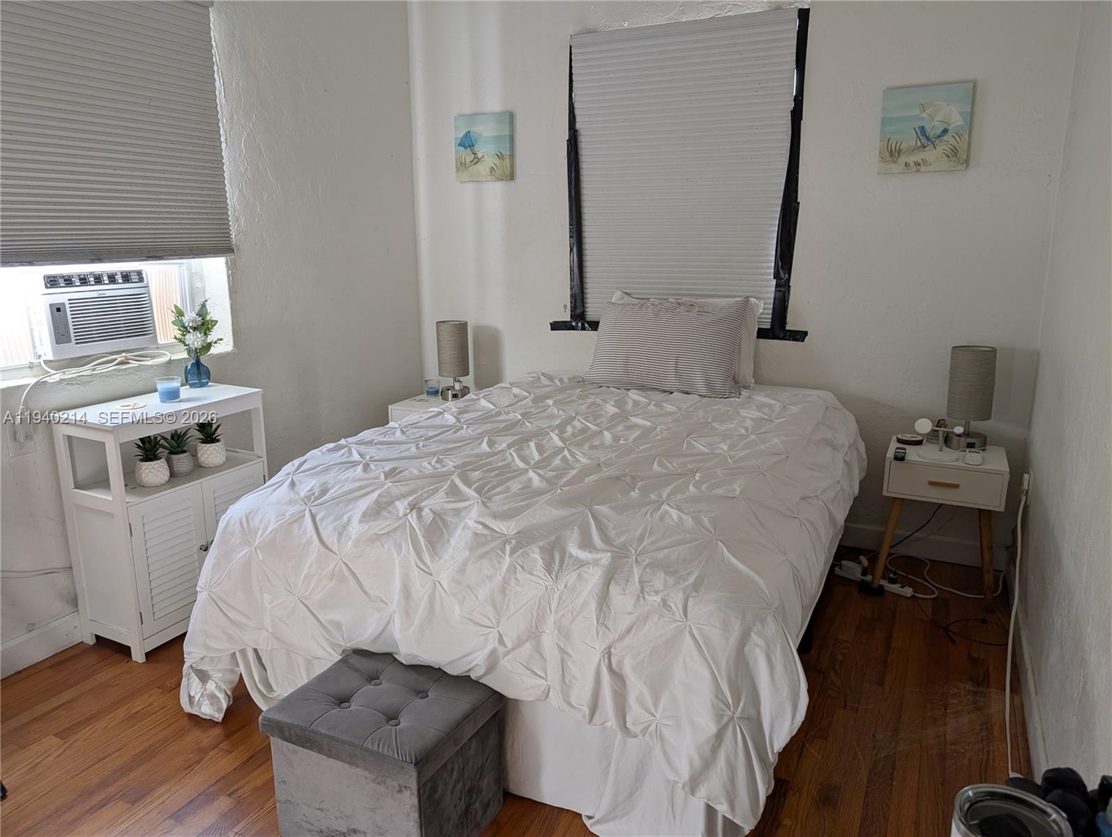 311 Southwest 2nd Avenue, Unit 1 Dania Beach, FL 33004 - Photo 5 of 14 a bed sitting in a bedroom next to a window