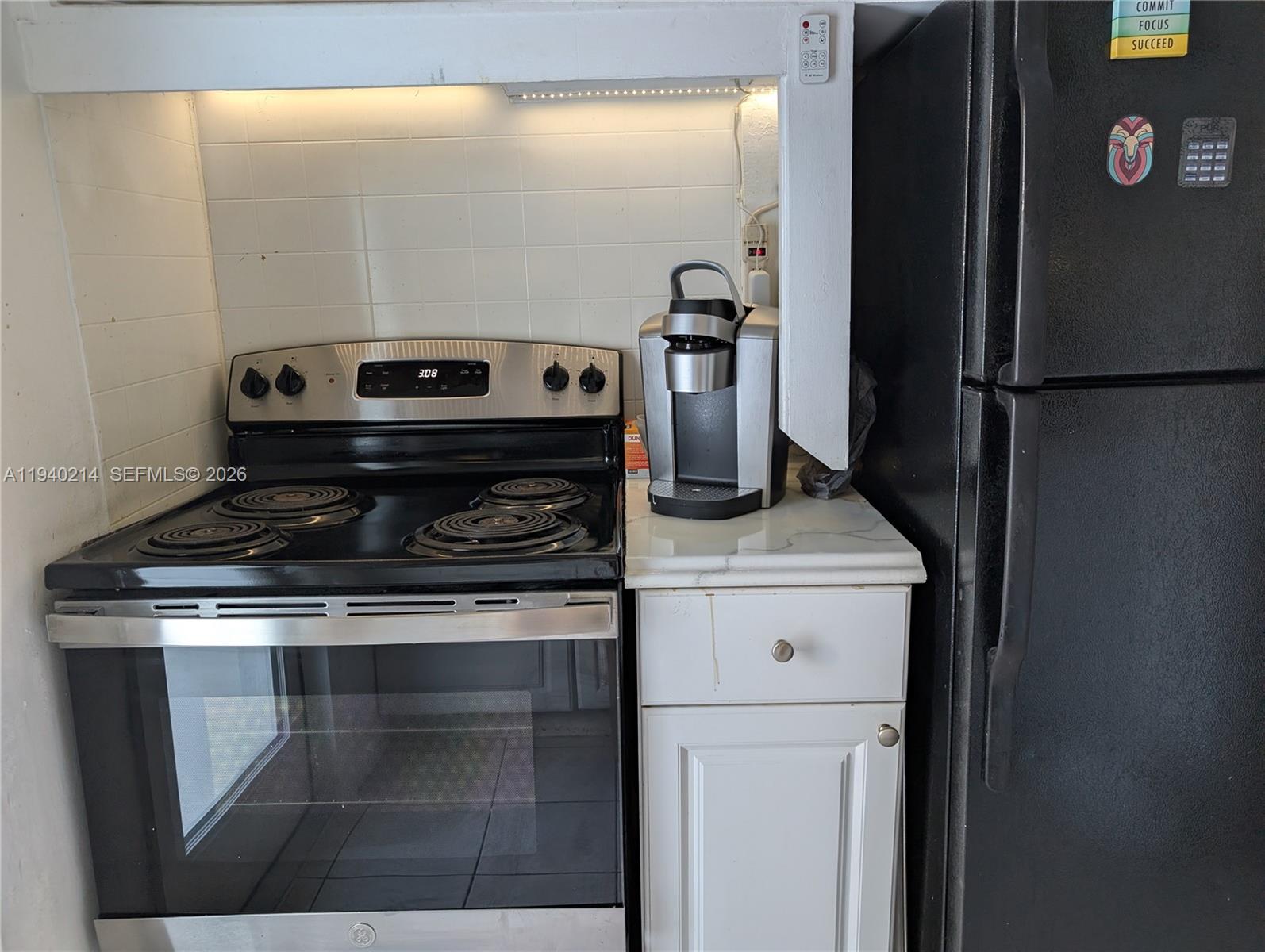 311 Southwest 2nd Avenue, Unit 1 Dania Beach, FL 33004 - Photo 8 of 14 a stove top oven sitting inside of a kitchen