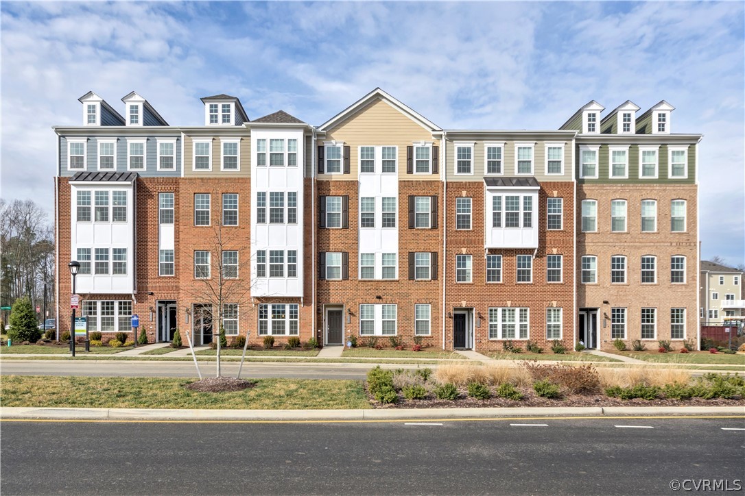4359 Saunders Station Loop, Unit B Richmond, VA 23233 - Photo 1 of 31 a front view of a residential apartment building with a yard