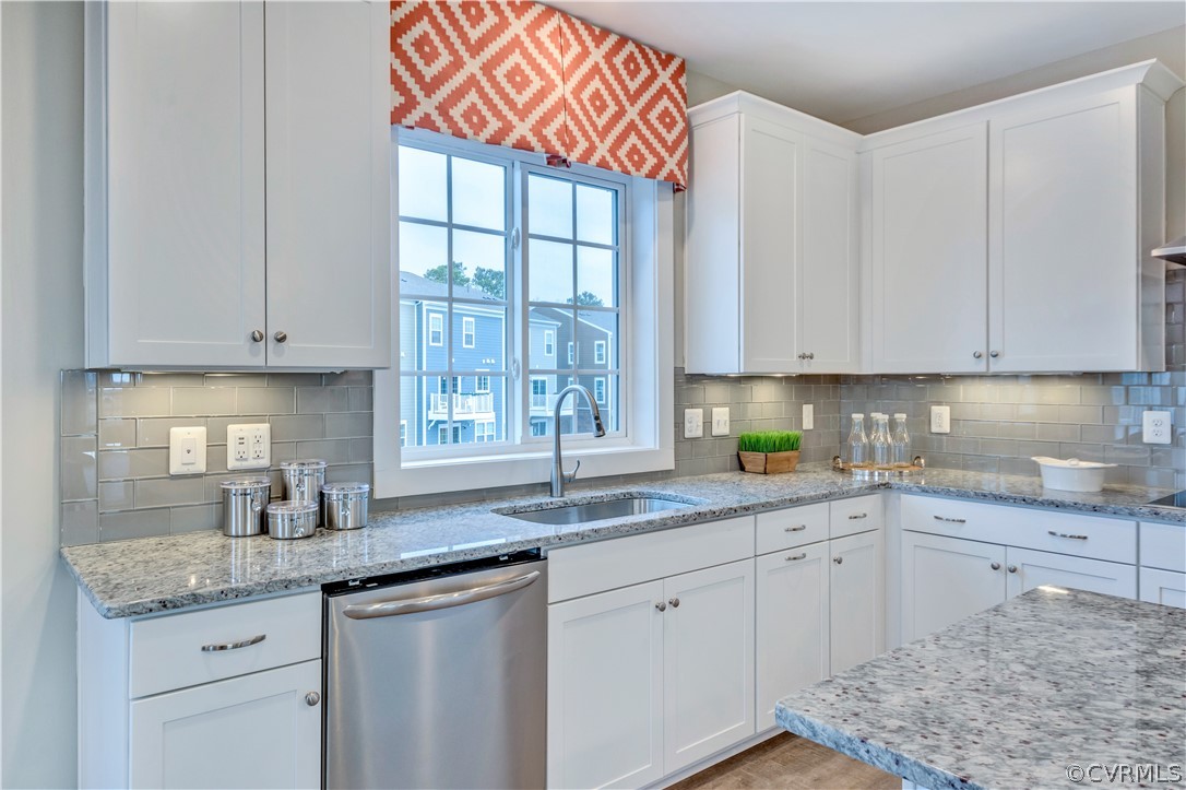 4359 Saunders Station Loop, Unit B Richmond, VA 23233 - Photo 15 of 31 a kitchen with stainless steel appliances granite countertop a sink and cabinets with wooden floor