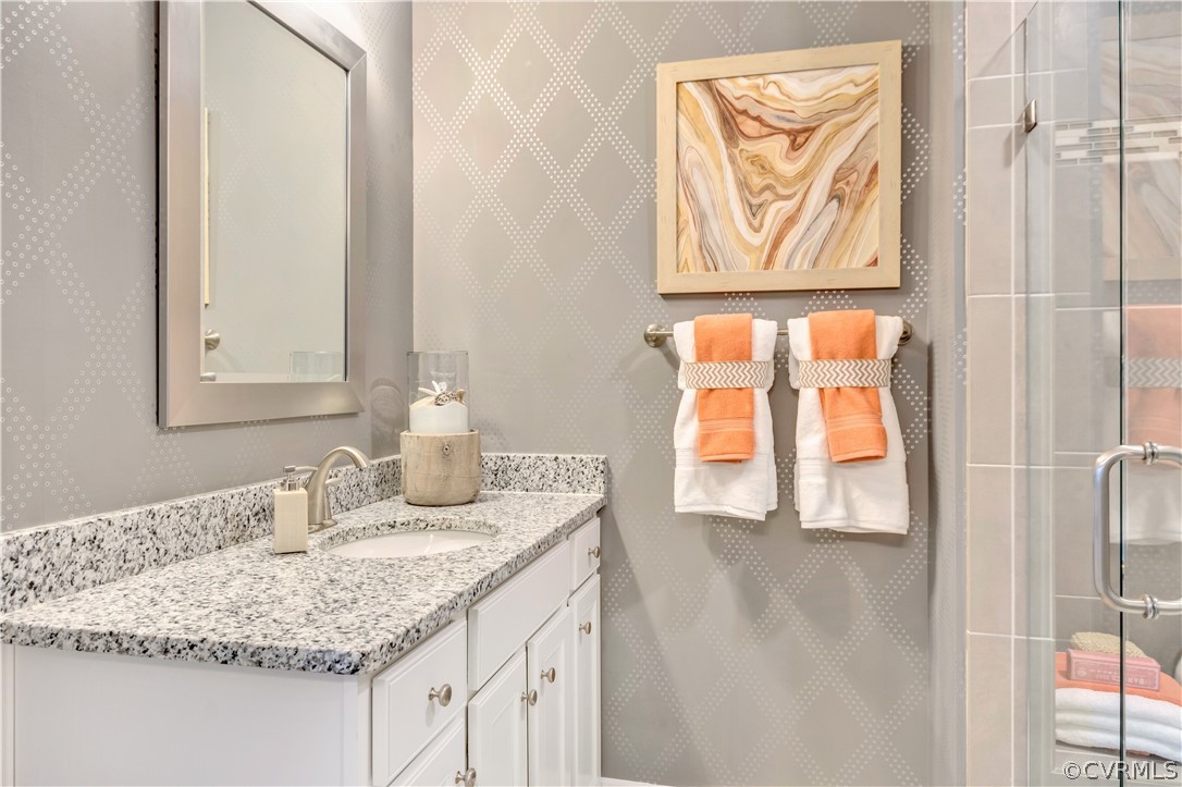 4359 Saunders Station Loop, Unit B Richmond, VA 23233 - Photo 24 of 31 a bathroom with a granite countertop sink and a mirror