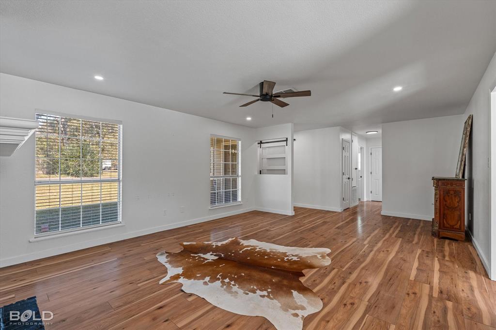 3407 Hickory Ridge Road Shreveport, LA 71108 - Photo 11 of 35 Unfurnished living room featuring wood finished floors, ceiling fan, and recessed lighting