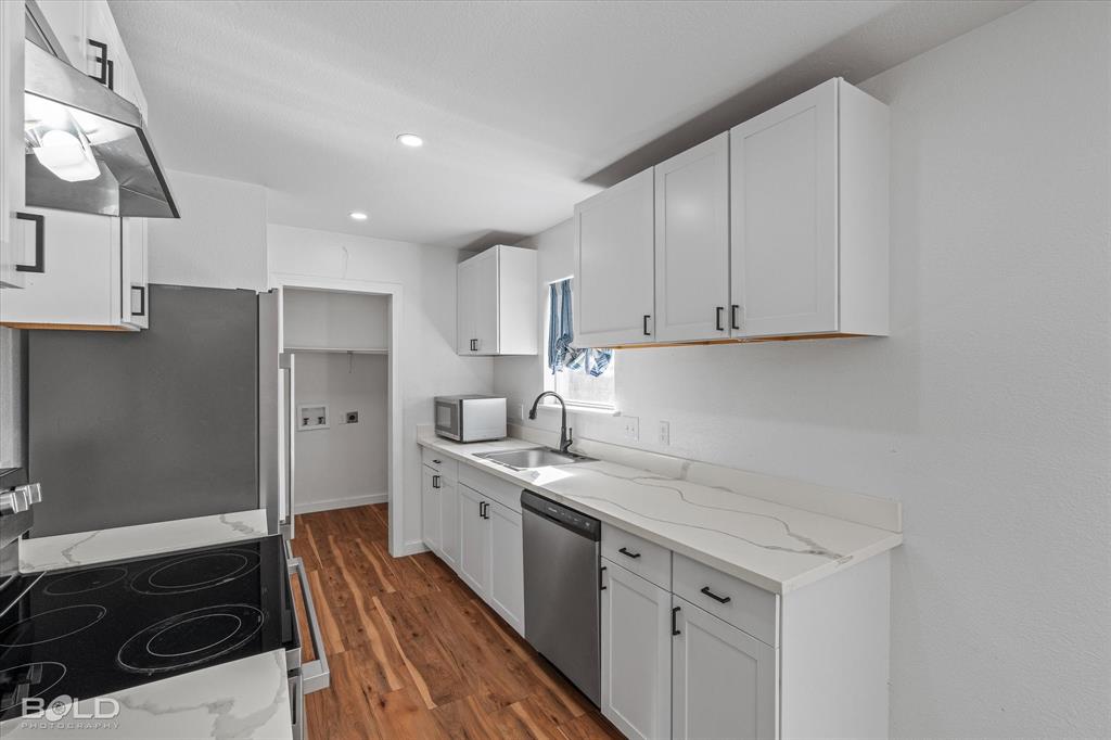 3407 Hickory Ridge Road Shreveport, LA 71108 - Photo 16 of 35 Kitchen with stainless steel appliances, white cabinets, exhaust hood, and recessed lighting