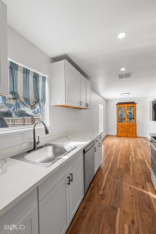 3407 Hickory Ridge Road Shreveport, LA 71108 - Photo 20 of 35 Kitchen with dark wood-style flooring, white cabinetry, appliances with stainless steel finishes, recessed lighting, and a textured ceiling