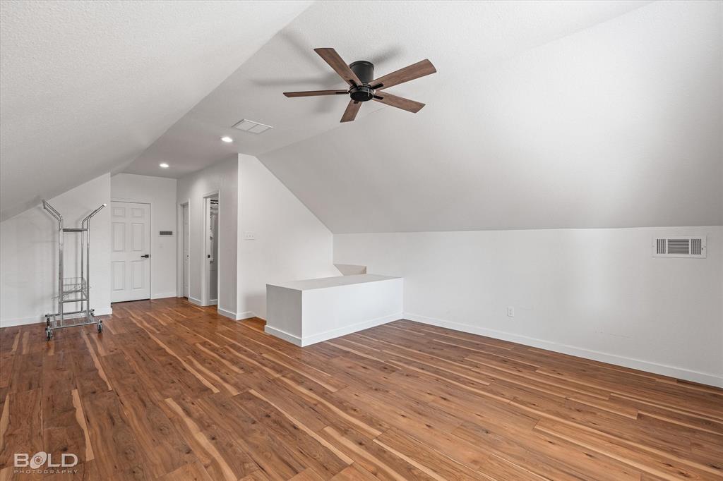 3407 Hickory Ridge Road Shreveport, LA 71108 - Photo 22 of 35 Bonus room featuring vaulted ceiling, dark wood finished floors, a ceiling fan, and a textured ceiling
