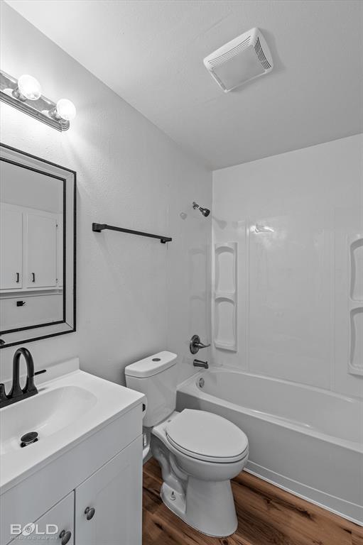 3407 Hickory Ridge Road Shreveport, LA 71108 - Photo 26 of 35 Bathroom featuring shower / washtub combination, dark wood-style flooring, and vanity