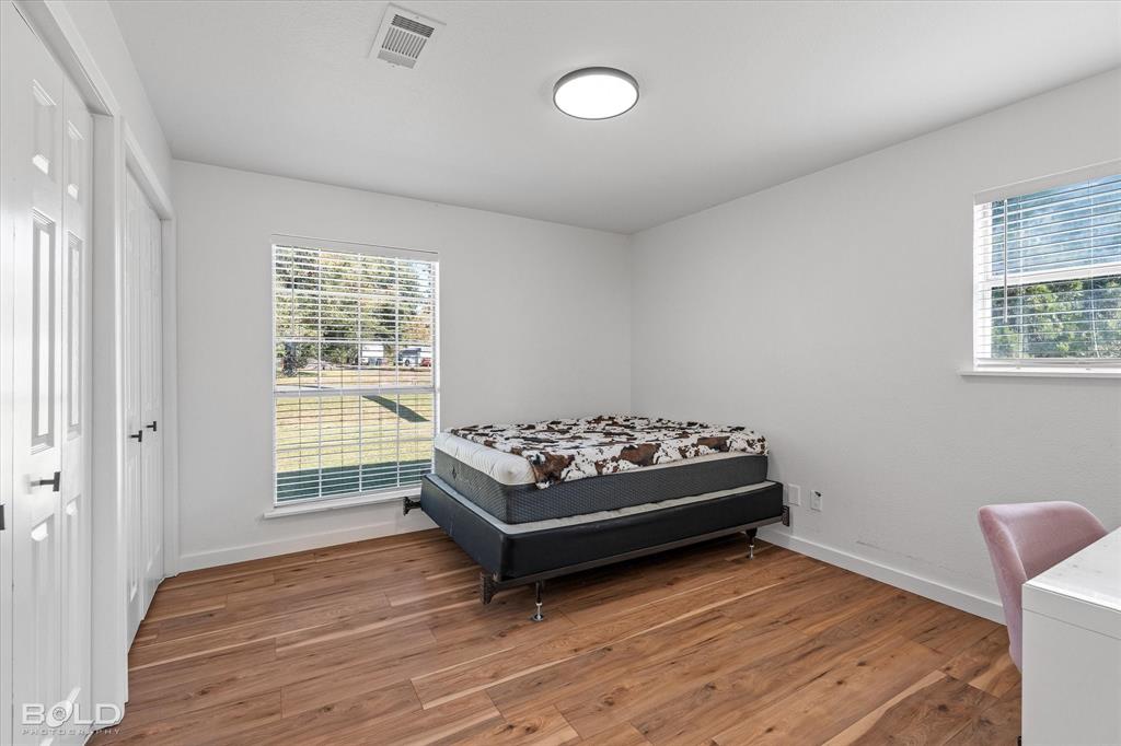 3407 Hickory Ridge Road Shreveport, LA 71108 - Photo 27 of 35 Bedroom with wood finished floors and multiple closets