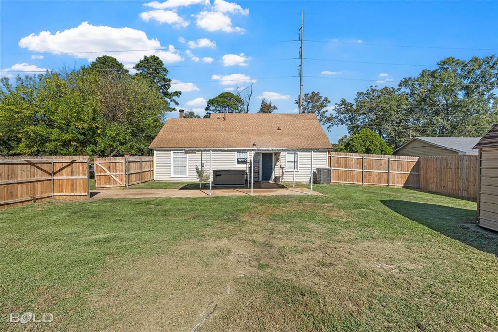 3407 Hickory Ridge Road Shreveport, LA 71108 - Photo 31 of 35 Back of property featuring a gate, a patio, a fenced backyard, a hot tub, and a shingled roof