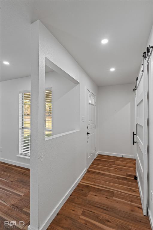 3407 Hickory Ridge Road Shreveport, LA 71108 - Photo 6 of 35 Hall with a barn door, recessed lighting, and dark wood-style floors