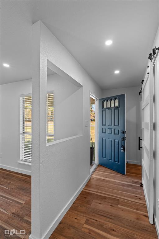 3407 Hickory Ridge Road Shreveport, LA 71108 - Photo 7 of 35 Foyer entrance with a barn door, wood finished floors, and recessed lighting