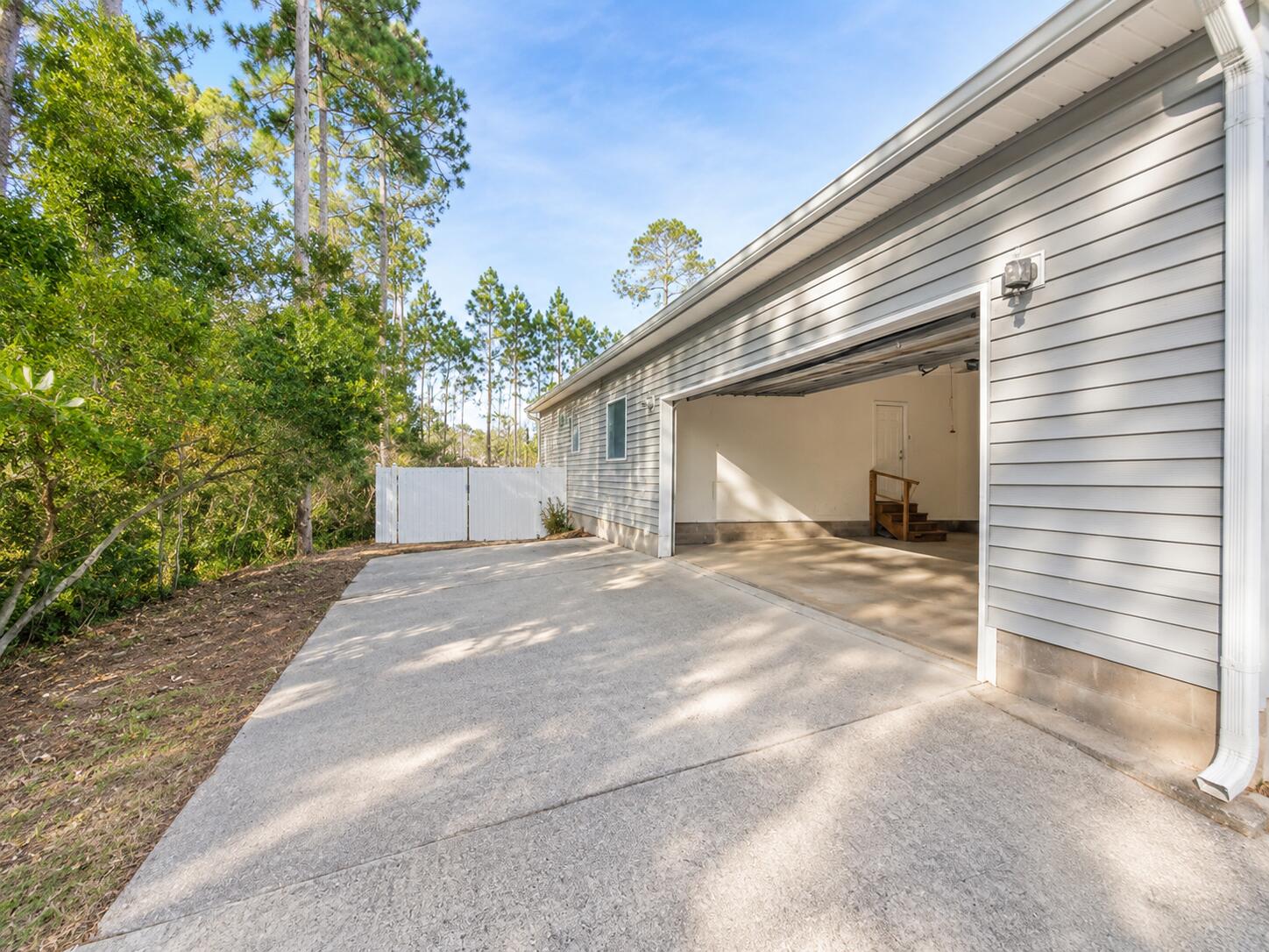 147 Dover Lane Freeport, FL 32439 - Photo 25 of 27 a view of a house with a yard and garage