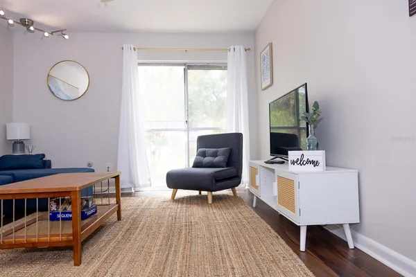 a living room with furniture and a flat screen tv