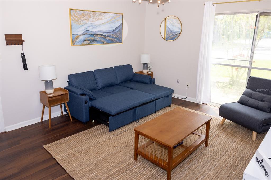 1700 Southwest 16th Court, Unit C5 Gainesville, FL 32608 - Photo 6 of 15 a living room with furniture a rug and a window