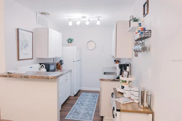 a bathroom with a granite countertop sink a mirror and vanity