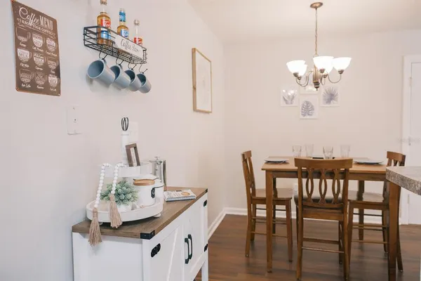 a view of a dining room with furniture and chandelier
