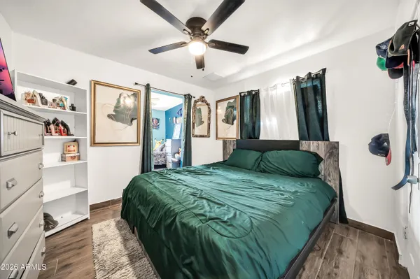 a kitchen with stainless steel appliances granite countertop a stove a refrigerator and a dining table with wooden floor