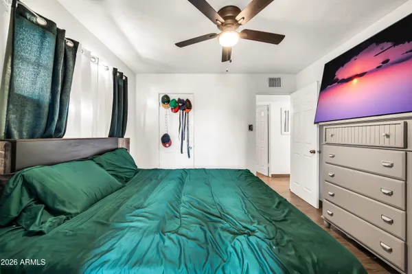 a kitchen with granite countertop white cabinets white appliances and a sink