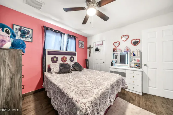 a bedroom with a large bed and a chandelier