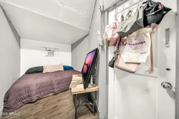 a bedroom with a bed and a window