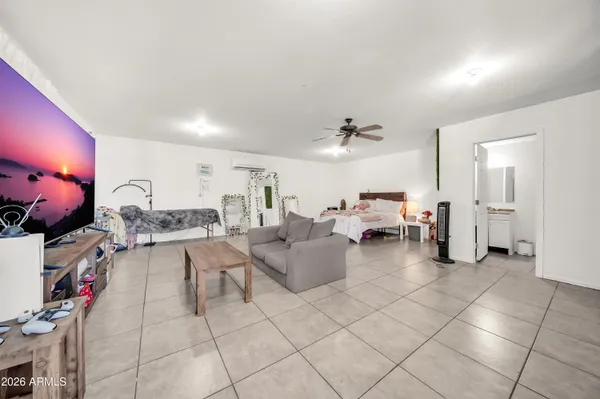 a bedroom with a bed and a painting on the wall