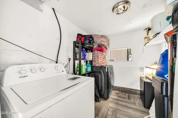 a spacious bedroom with a bed and a chandelier