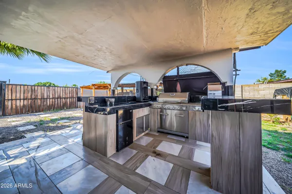 a view of a house with a yard and potted plants