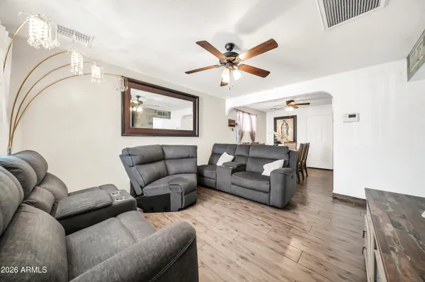 a patio with table and chairs and potted plants