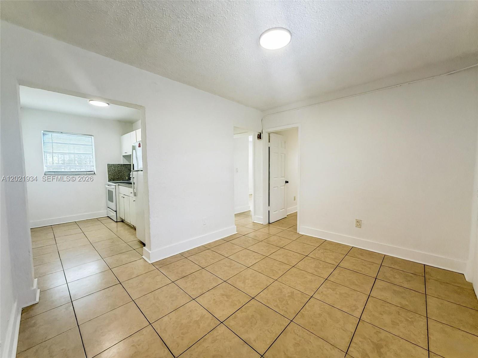 220 Northwest 11th Terrace, Unit 2 Miami, FL 33136 - Photo 2 of 9 an empty room with entrance and mirror