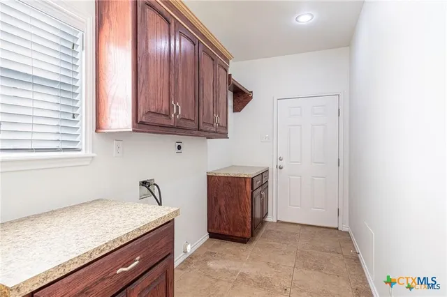 a kitchen with granite countertop cabinets and window