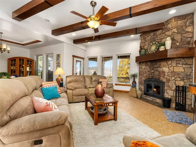 a living room with furniture ceiling fan and a fireplace