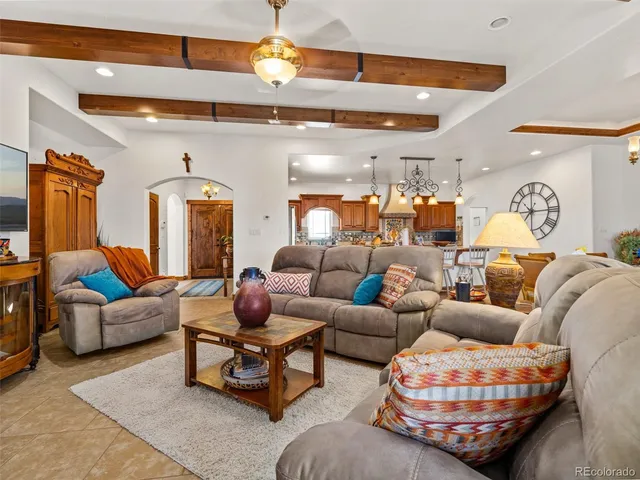 a living room with furniture a rug and a chandelier