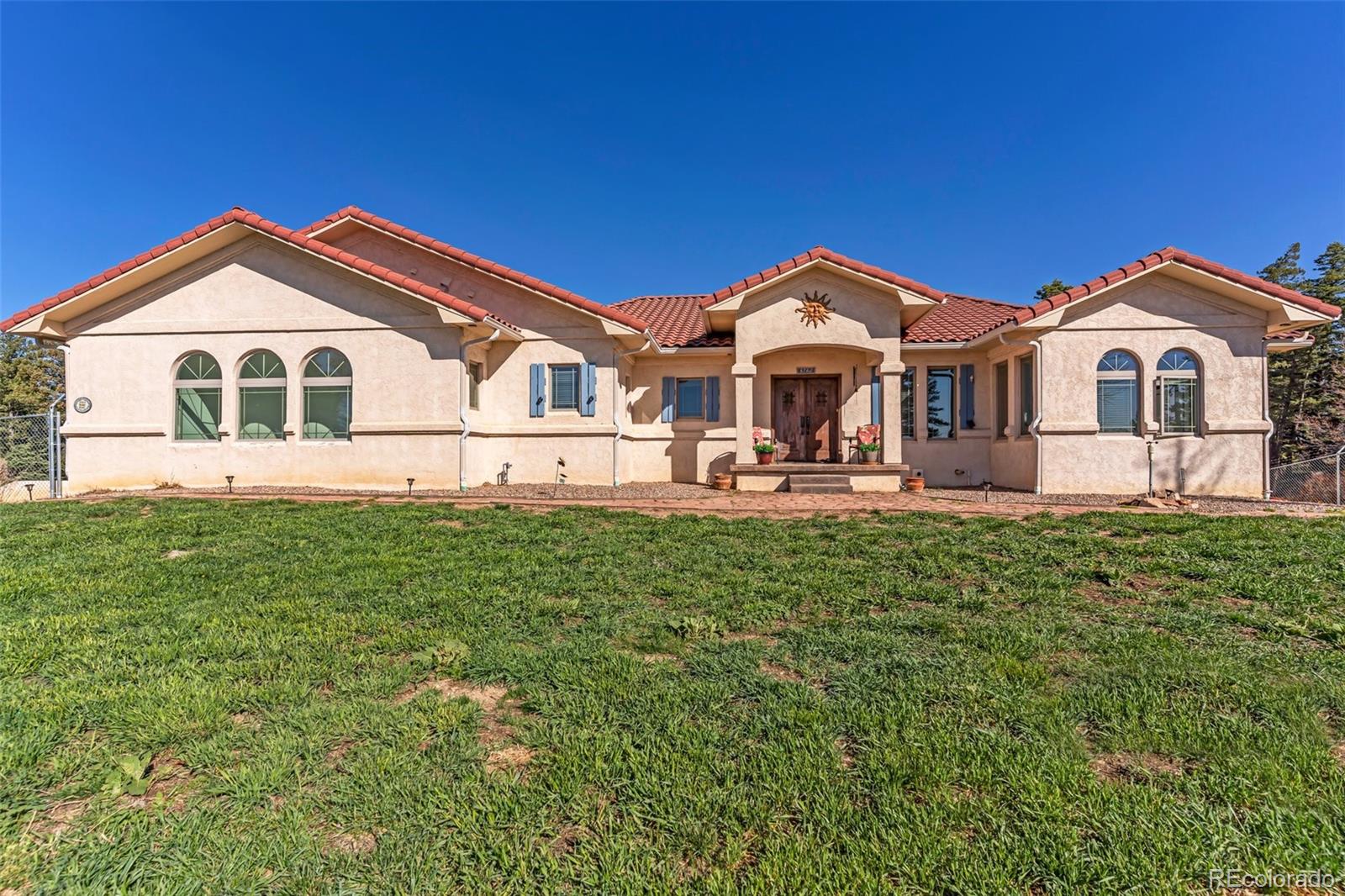 8760 Ridge Road Beulah, CO 81023 - Photo 2 of 49 a front view of a house with a yard