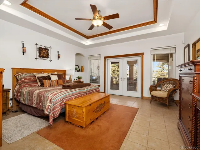 a spacious bedroom with a bed couch and a window