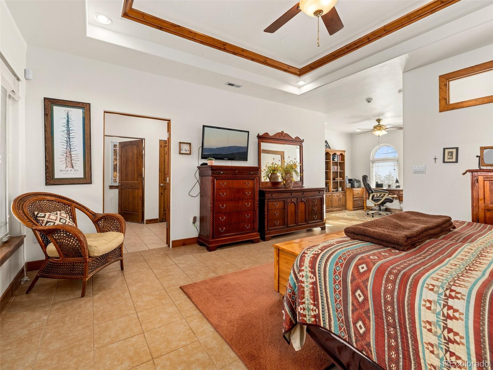 8760 Ridge Road Beulah, CO 81023 - Photo 24 of 49 a bedroom with a bed couch and a chandelier