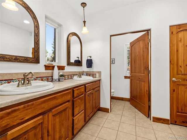 a bathroom with a double vanity sink and a mirror
