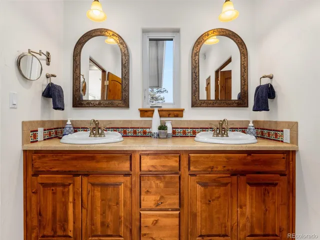 a bathroom with 2 sink and a mirror