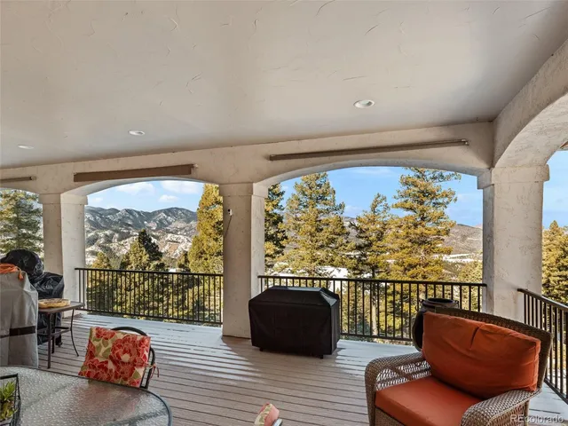 a balcony with furniture and a large window