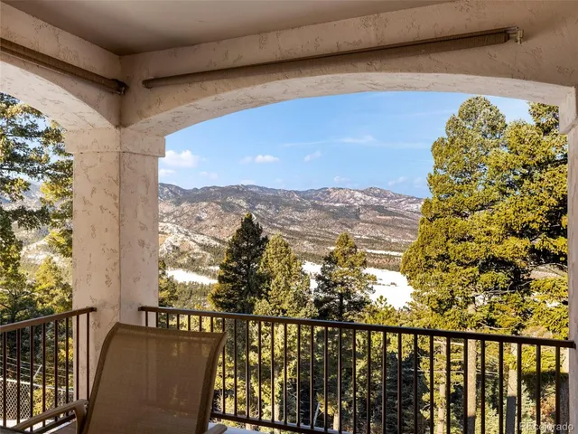a view of a balcony with wooden floor and city view