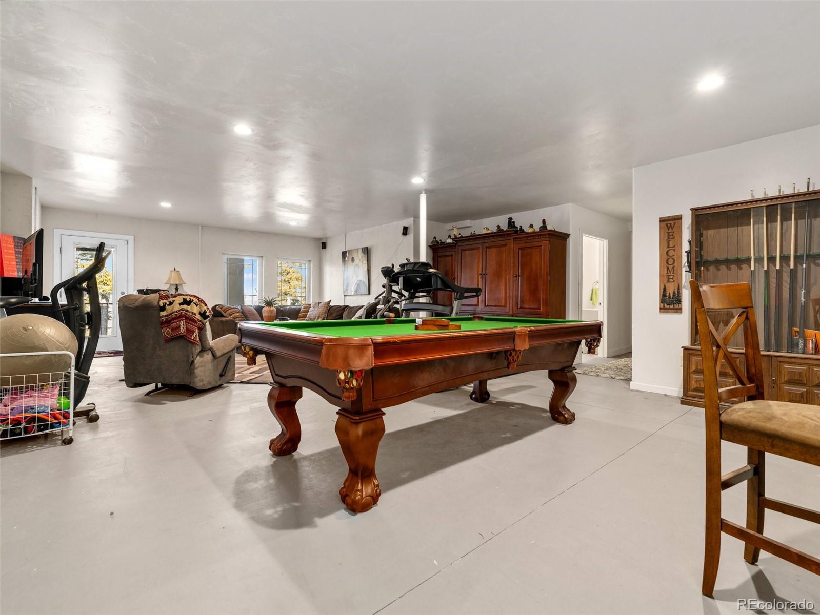 8760 Ridge Road Beulah, CO 81023 - Photo 38 of 49 a living room with furniture gym equipment and a table