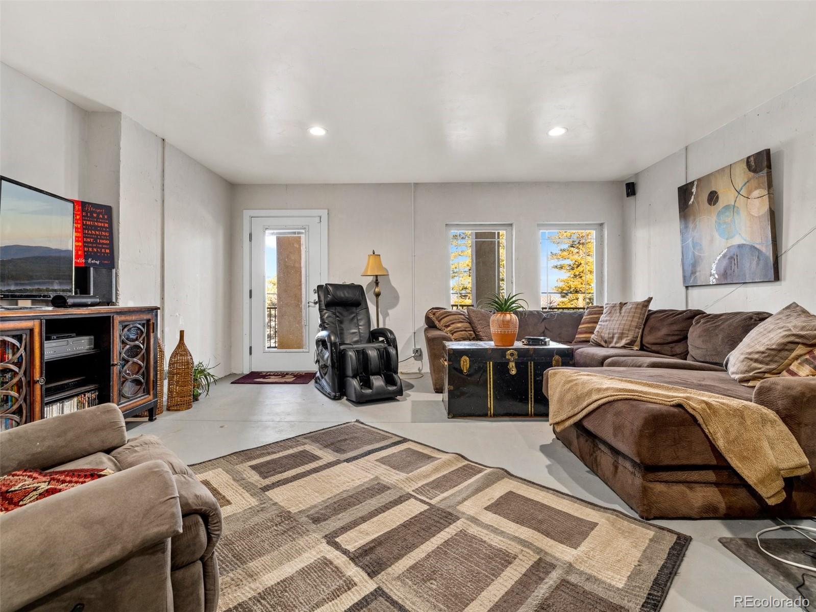 8760 Ridge Road Beulah, CO 81023 - Photo 39 of 49 a bed room with furniture and a flat screen tv