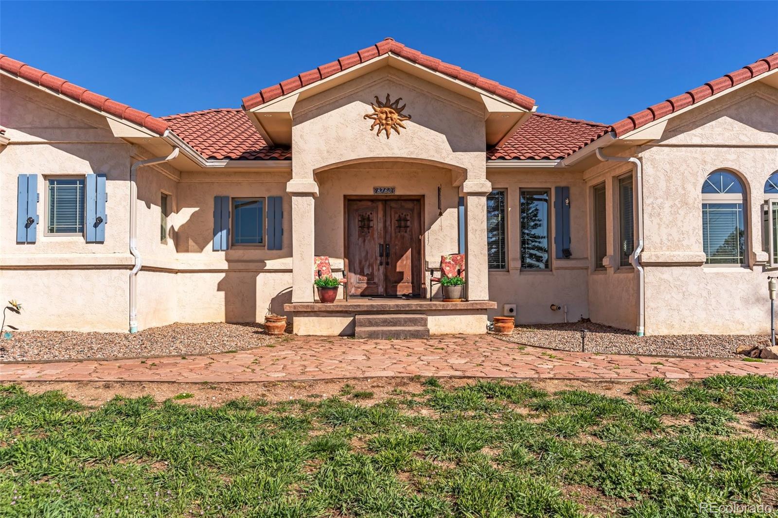 8760 Ridge Road Beulah, CO 81023 - Photo 4 of 49 a view of a house with large windows and a table and chairs