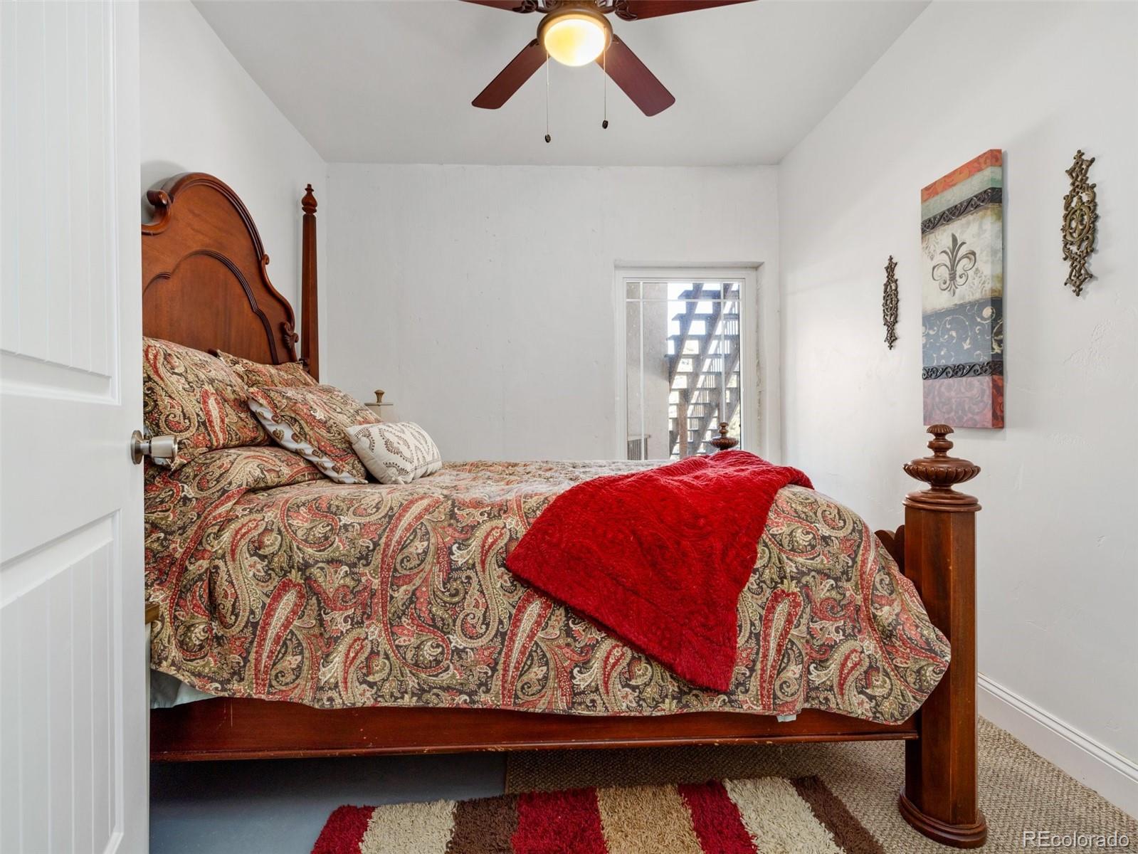 8760 Ridge Road Beulah, CO 81023 - Photo 42 of 49 a bed sitting in a bedroom next to a window