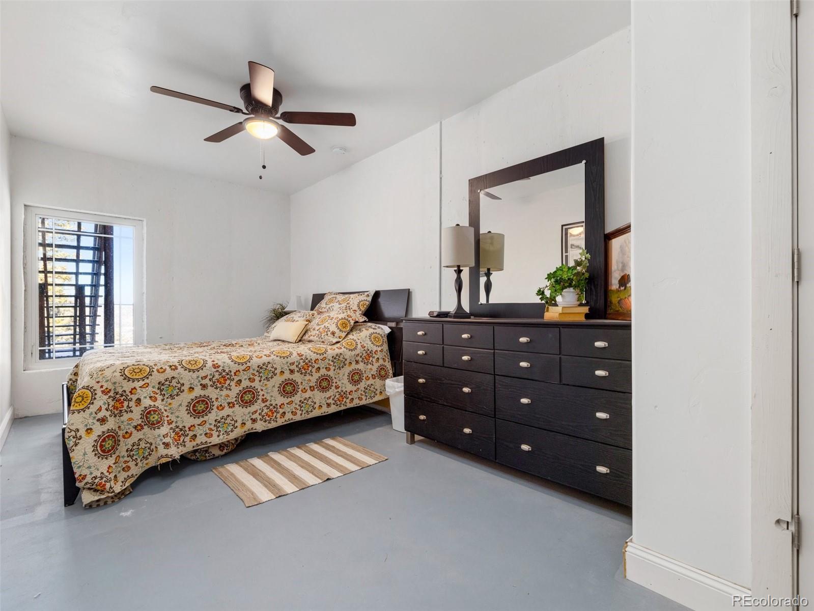 8760 Ridge Road Beulah, CO 81023 - Photo 43 of 49 a bedroom with a bed and a dresser