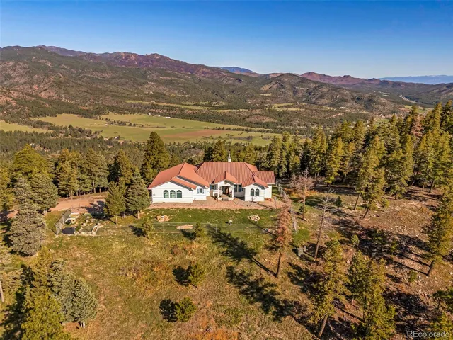 a view of a house with a yard and sitting area