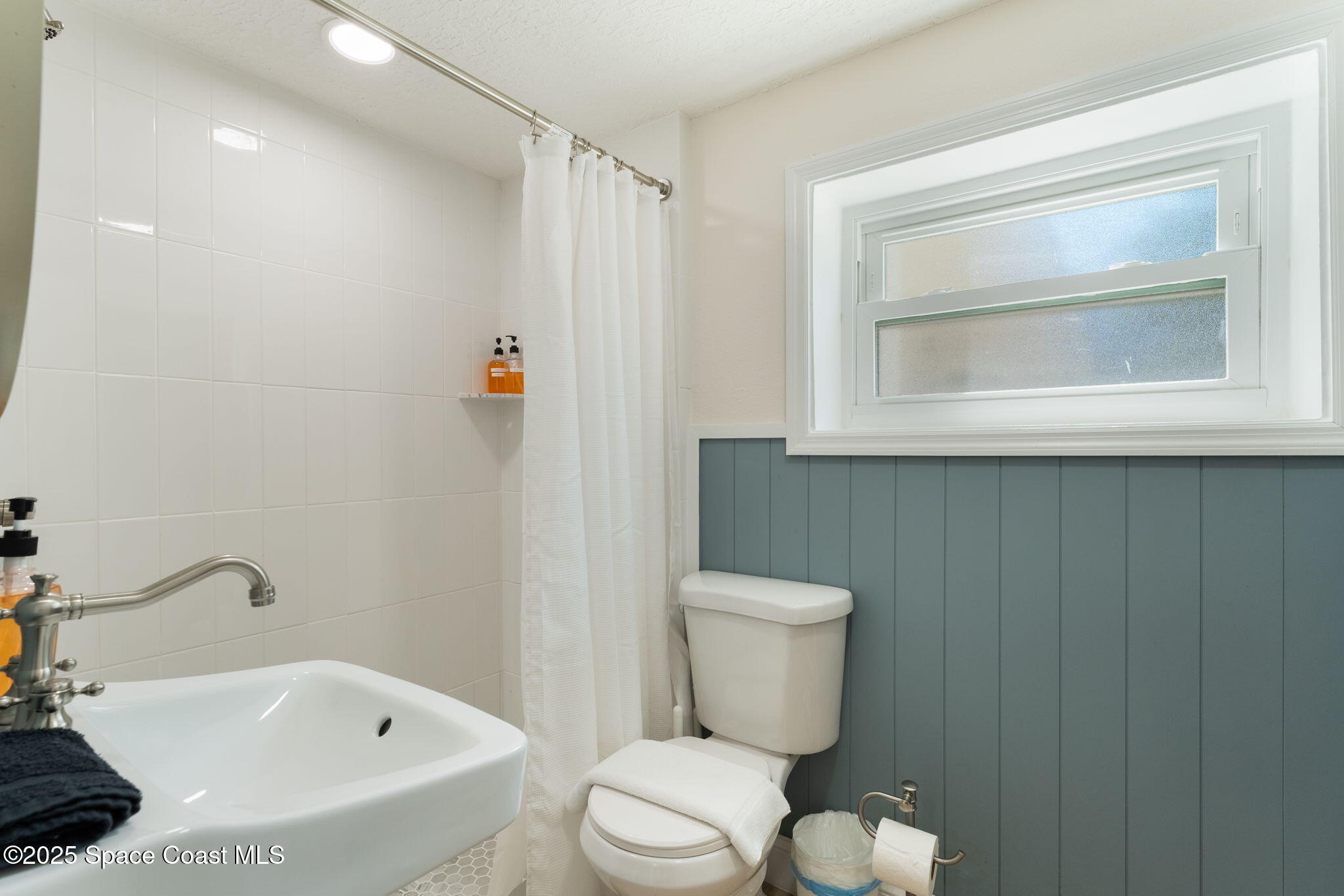 637 South Orlando Avenue Cocoa Beach, FL 32931 - Photo 15 of 83 a white toilet sitting next to a bathroom sink
