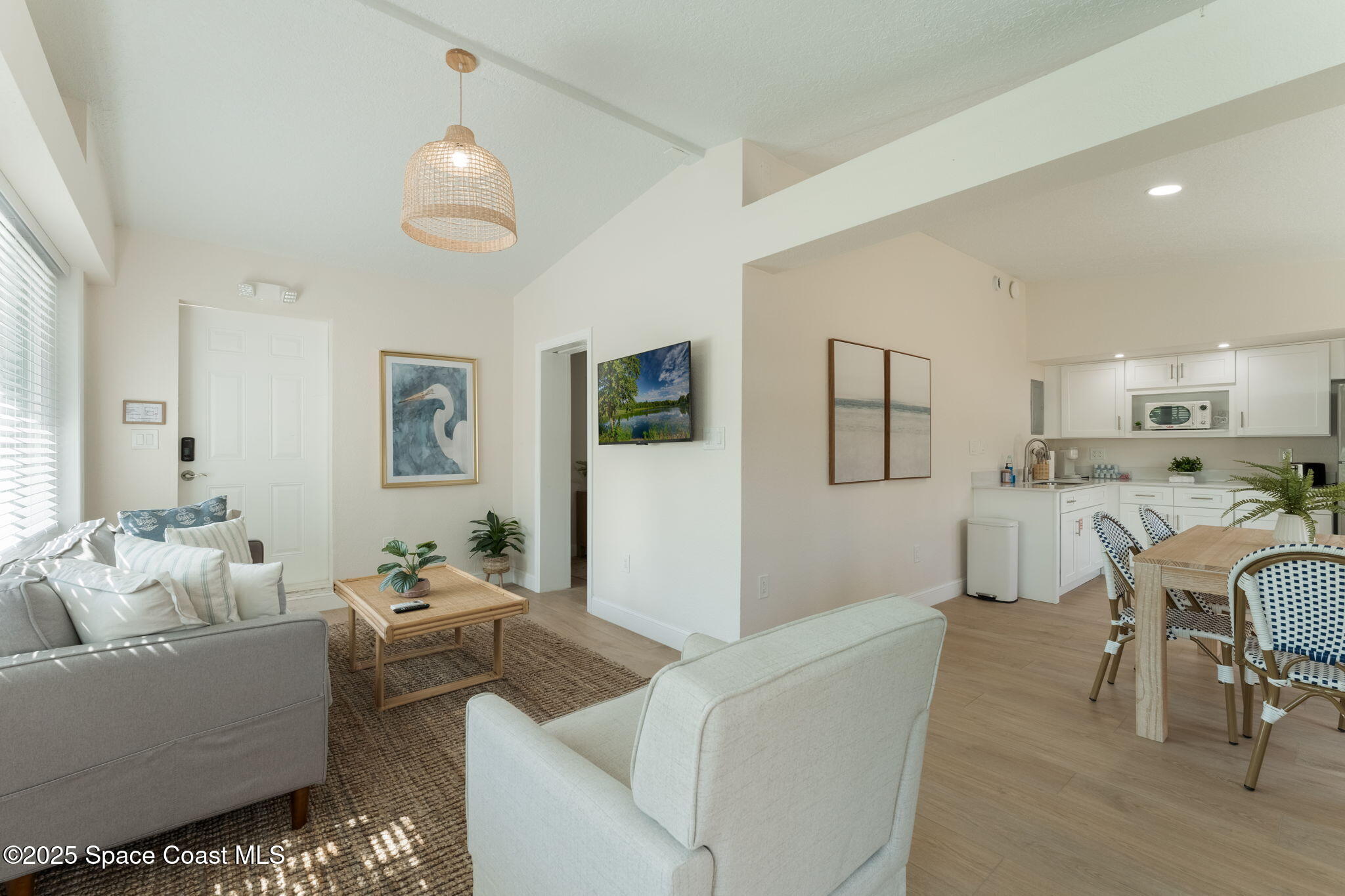 637 South Orlando Avenue Cocoa Beach, FL 32931 - Photo 17 of 83 a living room with furniture and a large window